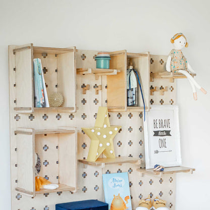 A Large Pegboard Display Stand shelf in a child's room with open storage shelves for books and toys, from Sweet HOME from wood.