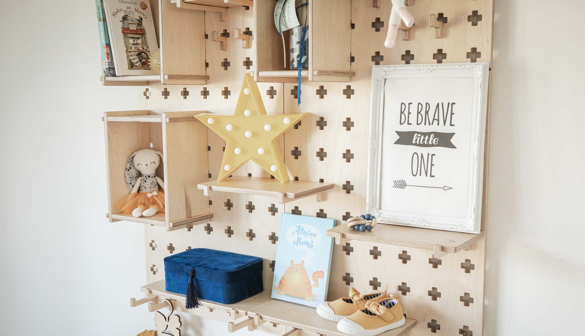 A child's room with a wooden wall shelf.