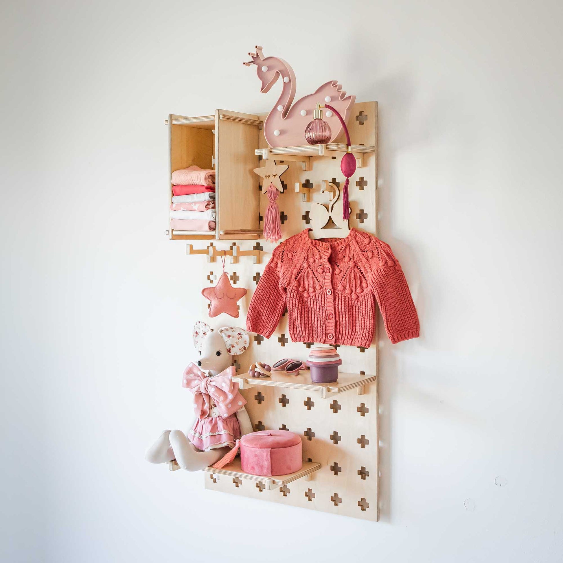 A Sweet HOME from wood Floating Shelves Pegboard with toys hanging on it.