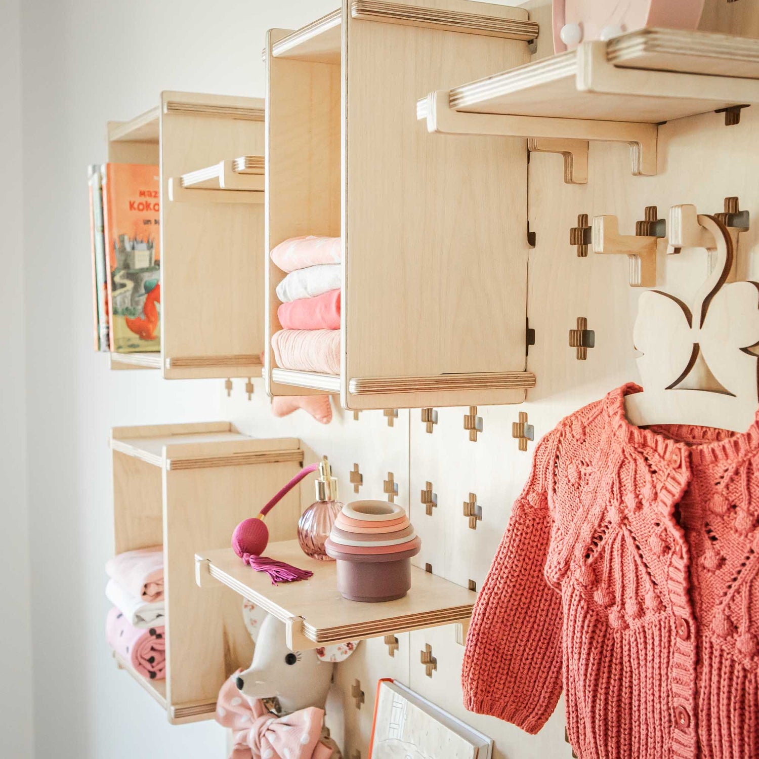 A toddler room with the Sweet HOME from wood Large Pegboard Display Stand.