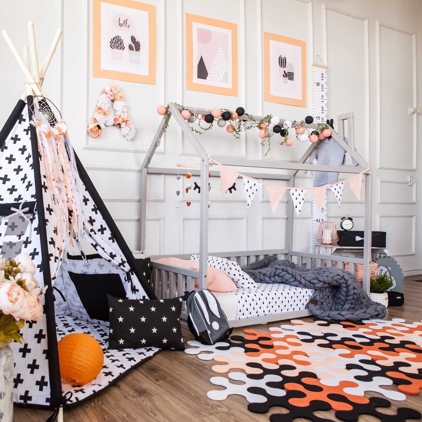 A Sweet Home From Wood Kids' house-frame bed with 3-sided rails transforms a child's room into a cozy sleep haven complete with a teepee, polka dots, and a cuddly teddy bear.