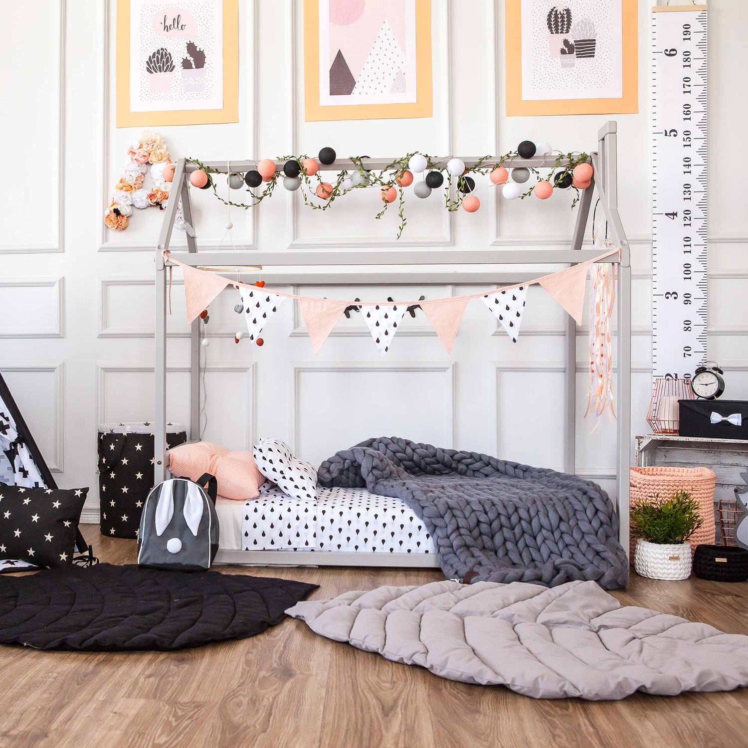 A black and white nursery with polka dots and bunting.