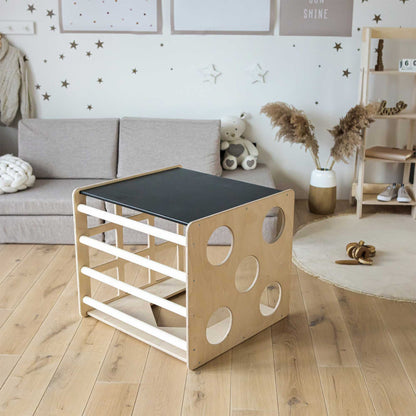 An Activity cube with sensory panels from Sweet Home From Wood in a child's room.