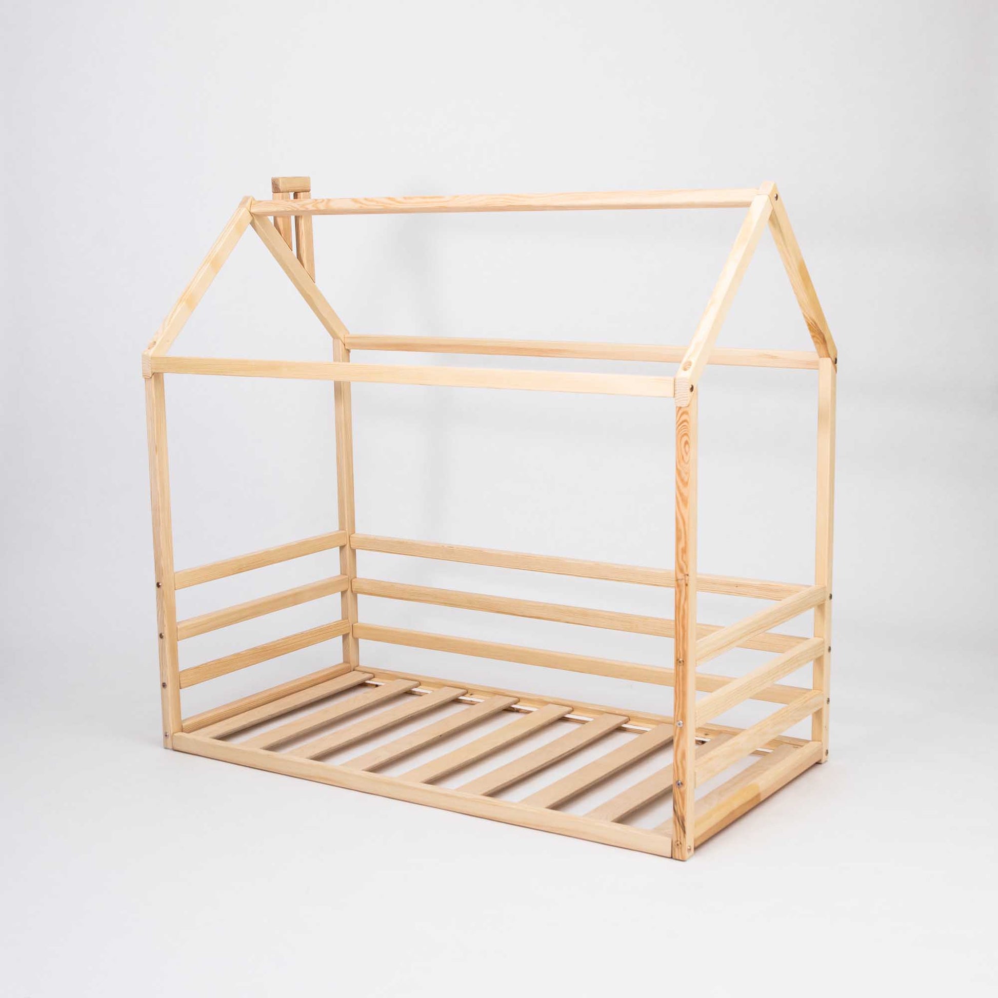 A Kids' house-frame bed with 3-sided horizontal rails, perfect for toddlers and kids who prefer a floor level sleeping option.
