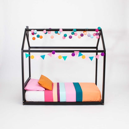 A Sweet Home From Wood House-frame Bed with a headboard covered in colorful pom poms, creating a cozy sleep haven.