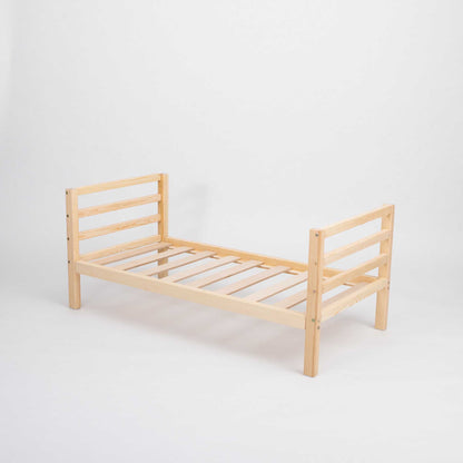 A long-lasting Sweet Home From Wood 2-in-1 kids' bed with a horizontal rail headboard and footboard, with slats that can grow with a child, set against a white background.