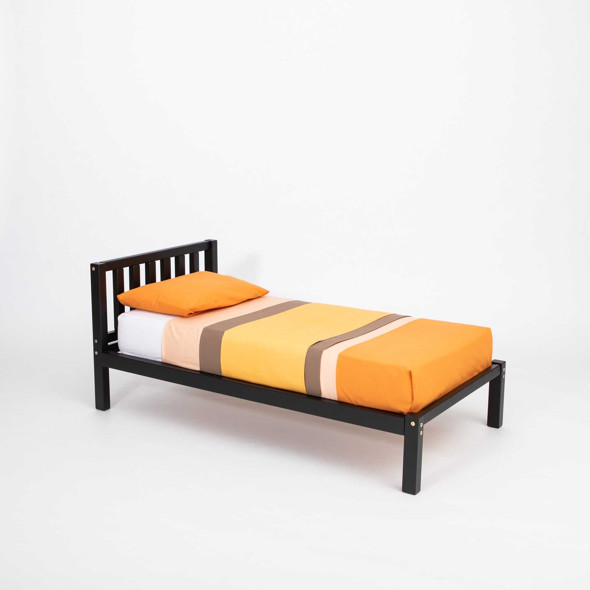 A Sweet Home From Wood Montessori-inspired children's bed on legs with a headboard, featuring a black frame and orange sheets, promoting independence in a solid wood design.