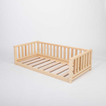 A Sweet Home From Wood 2-in-1 toddler bed on legs with a 3-sided vertical rail made of solid pine wood with slats, perfect for a floor-level sleeping experience.