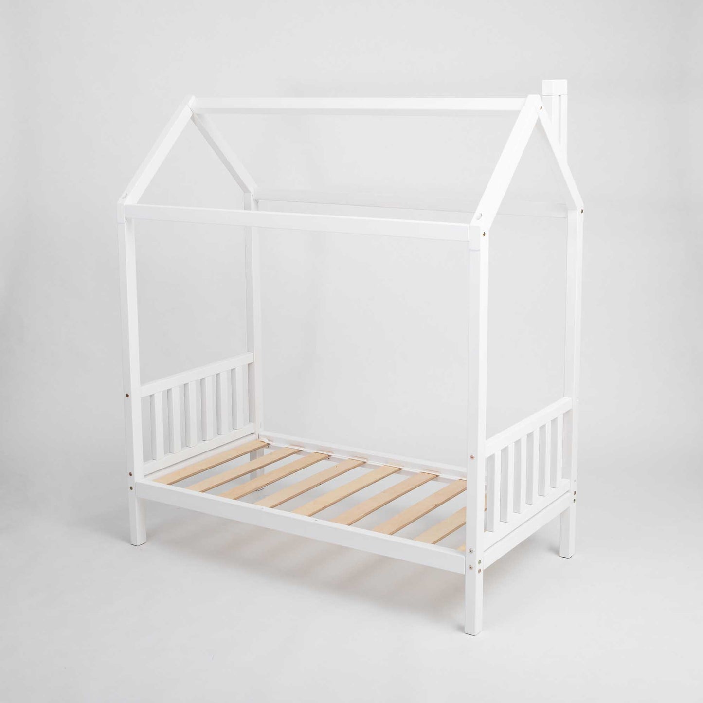 A white raised toddler house bed on legs with a wooden frame and slats.