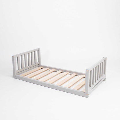 A Montessori-inspired Kids' bed with a headboard and footboard on a white background.