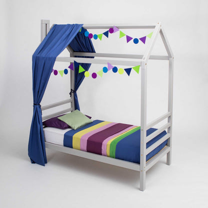 A Kids' house bed on legs with a headboard and footboard with a canopy and bunting.