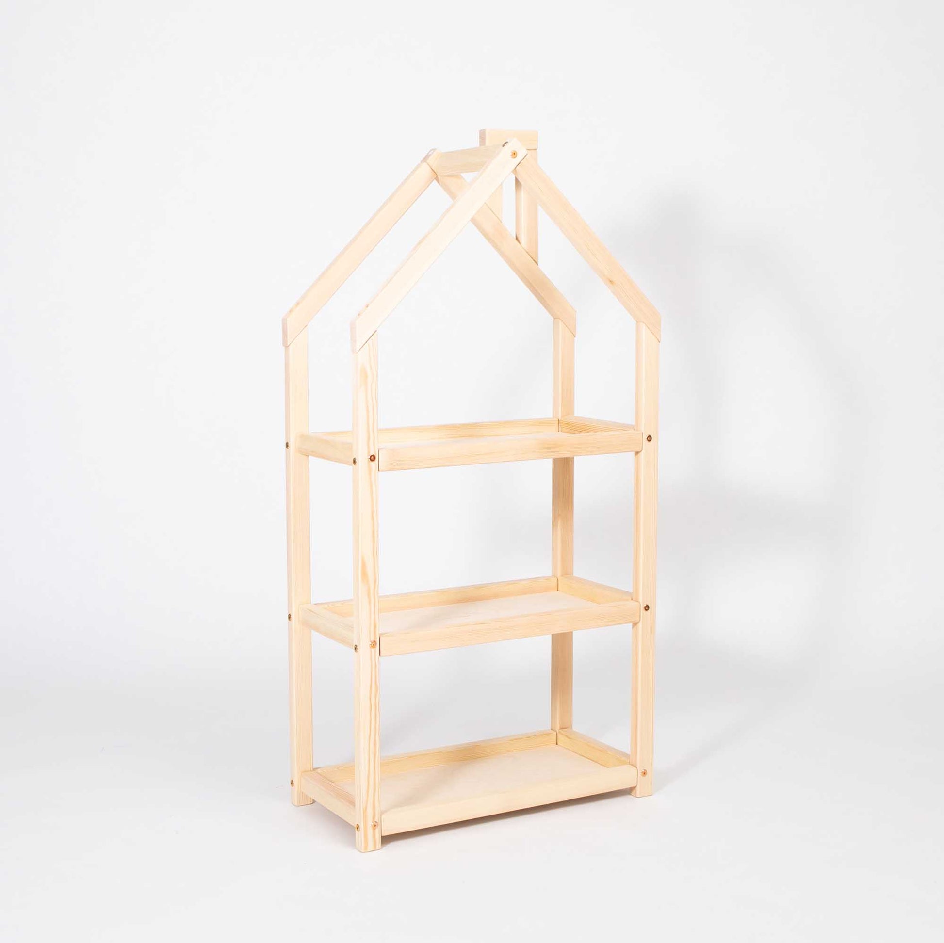 A House-shaped Montessori shelf from Sweet Home From Wood with a wooden house on it.
