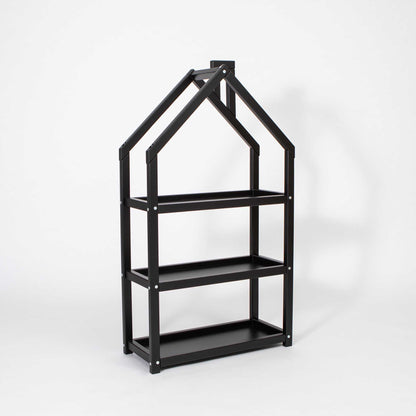 A black House-shaped Montessori shelf with a doll house on it from Sweet Home From Wood.