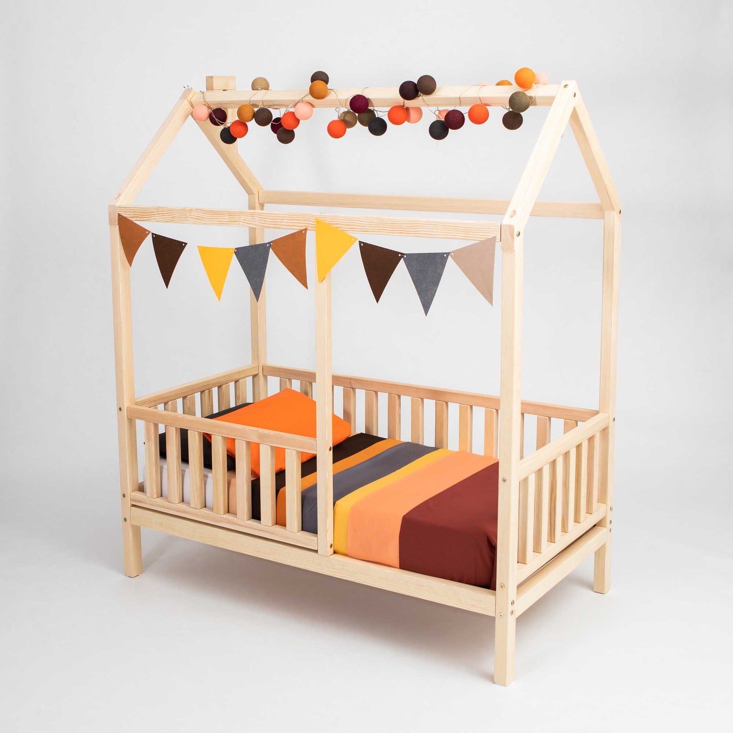 A Kids' house bed on legs with a fence, perfect as a toddler bed.
