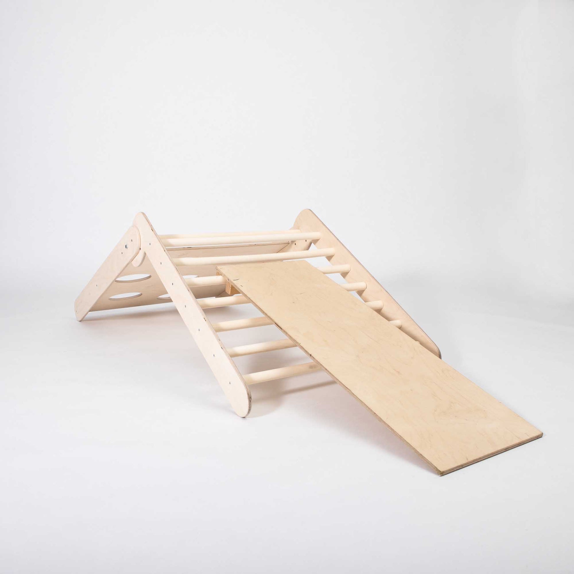 A Transformable climbing triangle with 2 sensory panels with a slide on it.