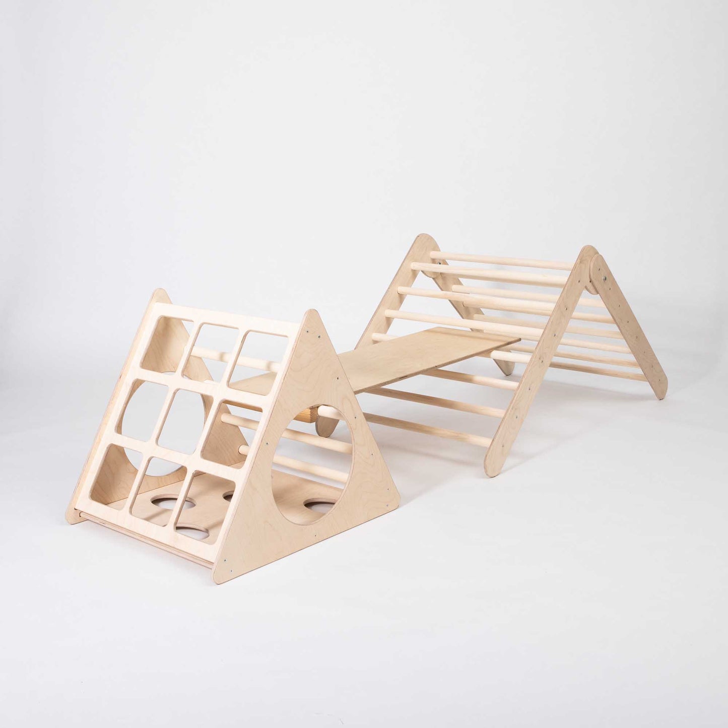 A wooden play structure with a Sweet Home From Wood climbing triangle on it.