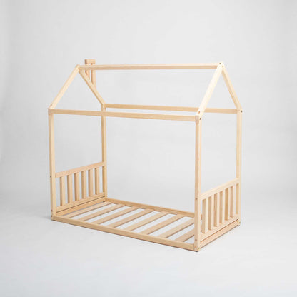 This Sweet Home From Wood Toddler House Bed features a cozy sleep haven for preschool-aged children, complete with a wooden frame and slats.