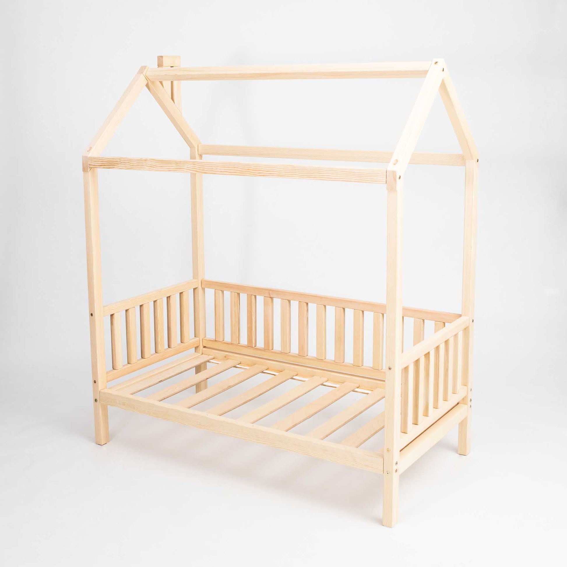 A Raised house bed on legs with 3-sided rails with a slatted roof.