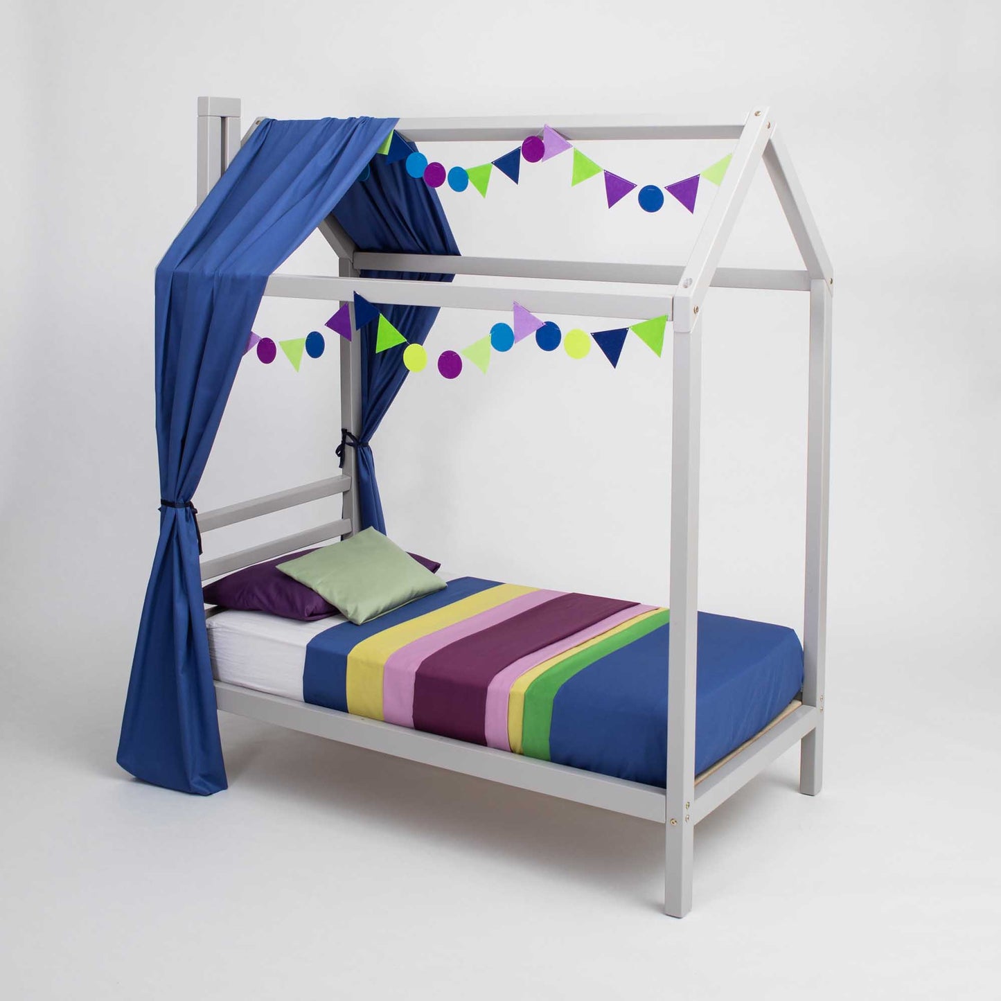 A child's Kids' house bed on legs with a headboard with a canopy and bunting.