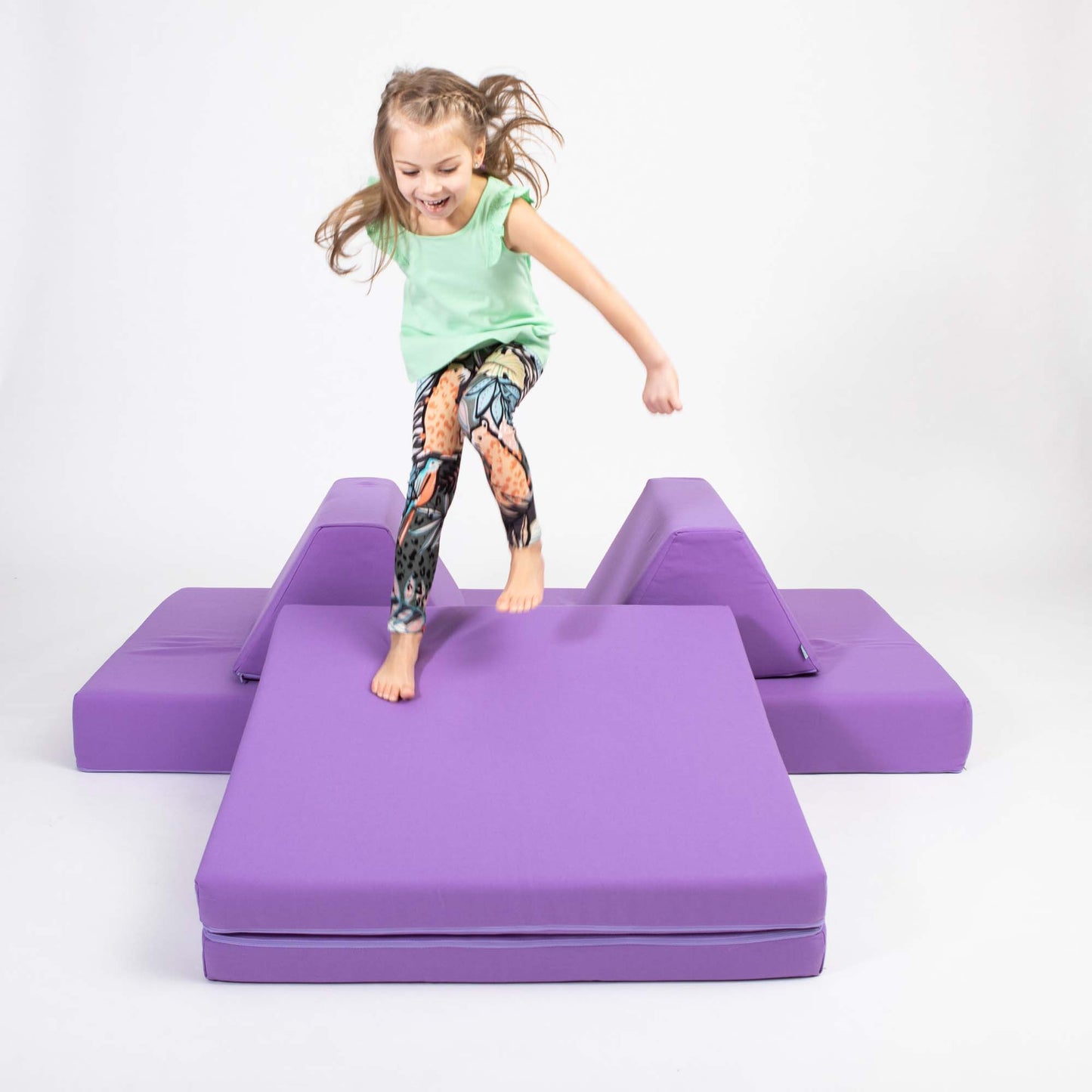 Foldable soft play mattress for children’s room, designed for climbing, sitting, and creative play.