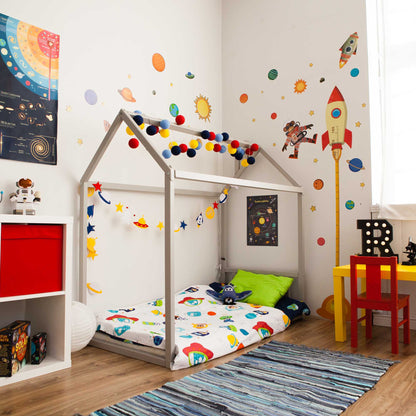 A cozy sleep space for a child with a Sweet Home From Wood Montessori House Bed and a desk.