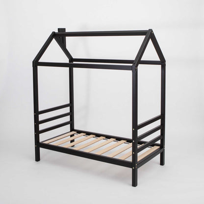 A raised Kids' house bed on legs with wooden slats.