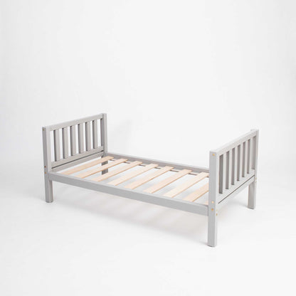 A Sweet Home From Wood Montessori-inspired grey wooden bed with wooden slats on a white background, promoting independence for children.