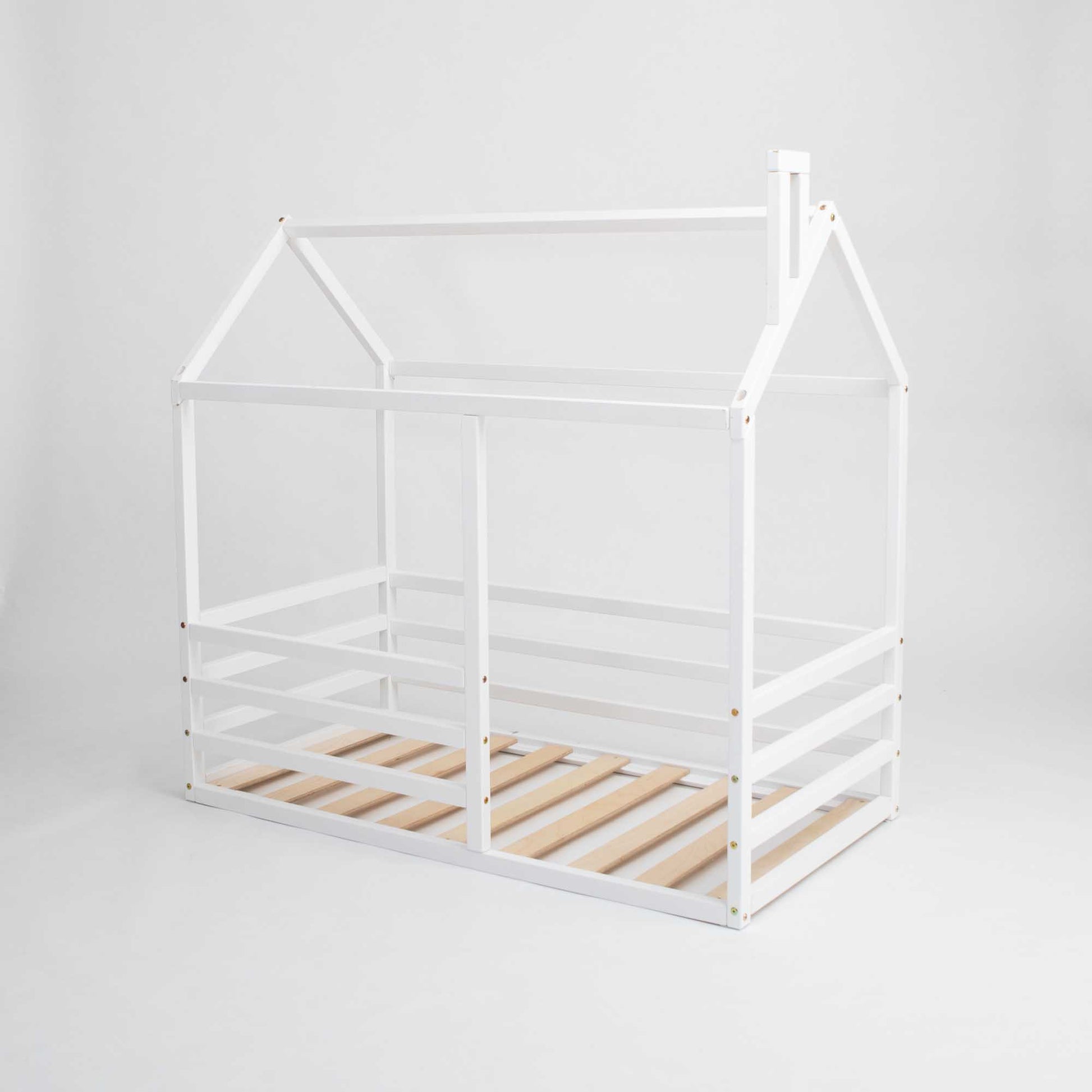 A white wooden floor level house bed with a horizontal fence and wooden slats.