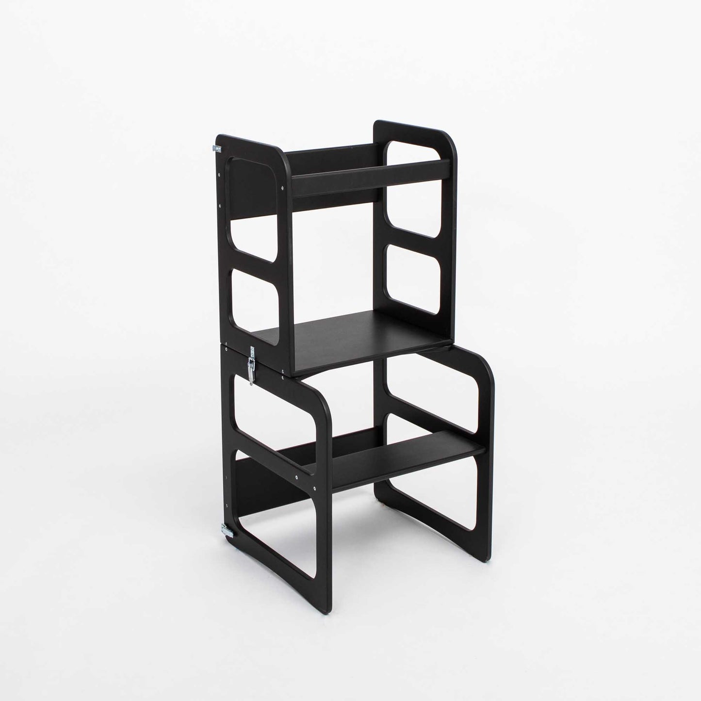 A black Montessori step stool, serving both as a 2-in-1 transformable kitchen tower - table and chair set or Montessori step stool.