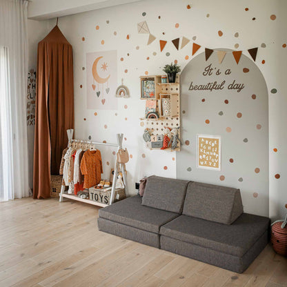 A toddler's room with a colorful theme featuring a Sweet Home From Wood Kids' open clothing rack with storage.