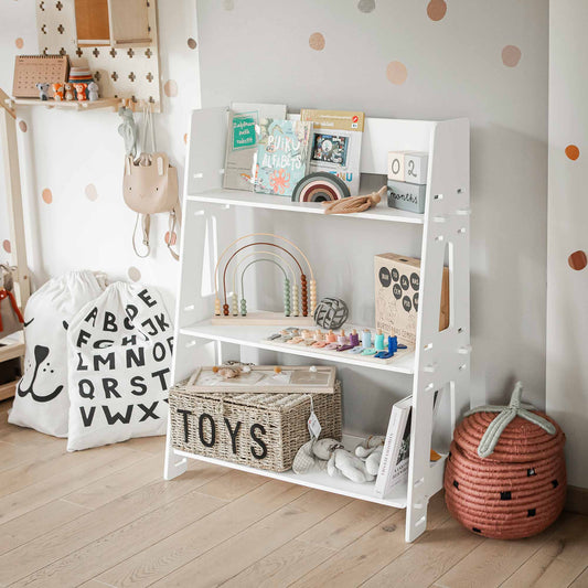 A Montessori open toy shelf with various office supplies and decorative items, neatly organized for a child's bedroom.
