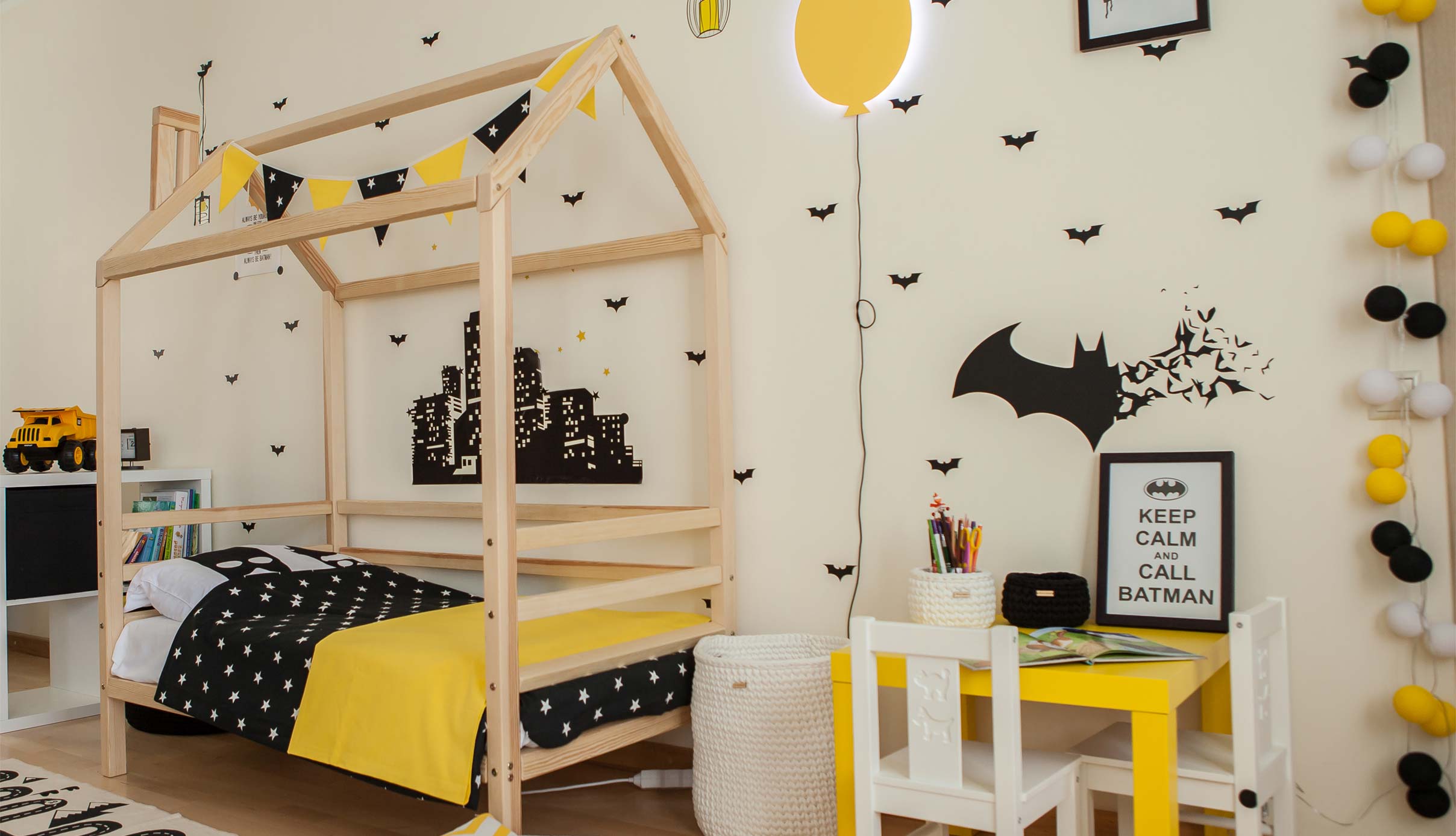 A boy's bedroom with a batman theme.