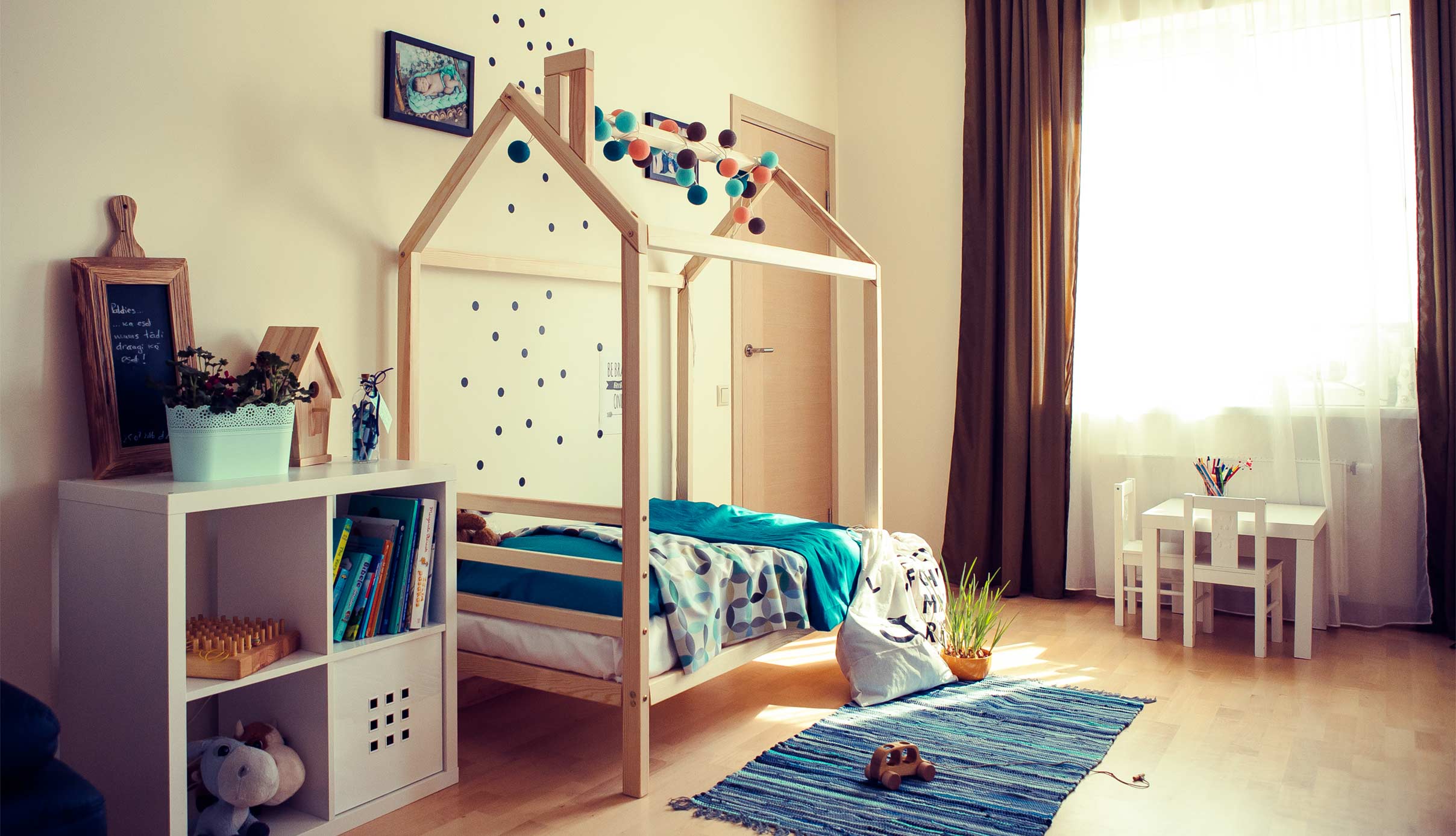 A child's room with a wooden bed and a toy.