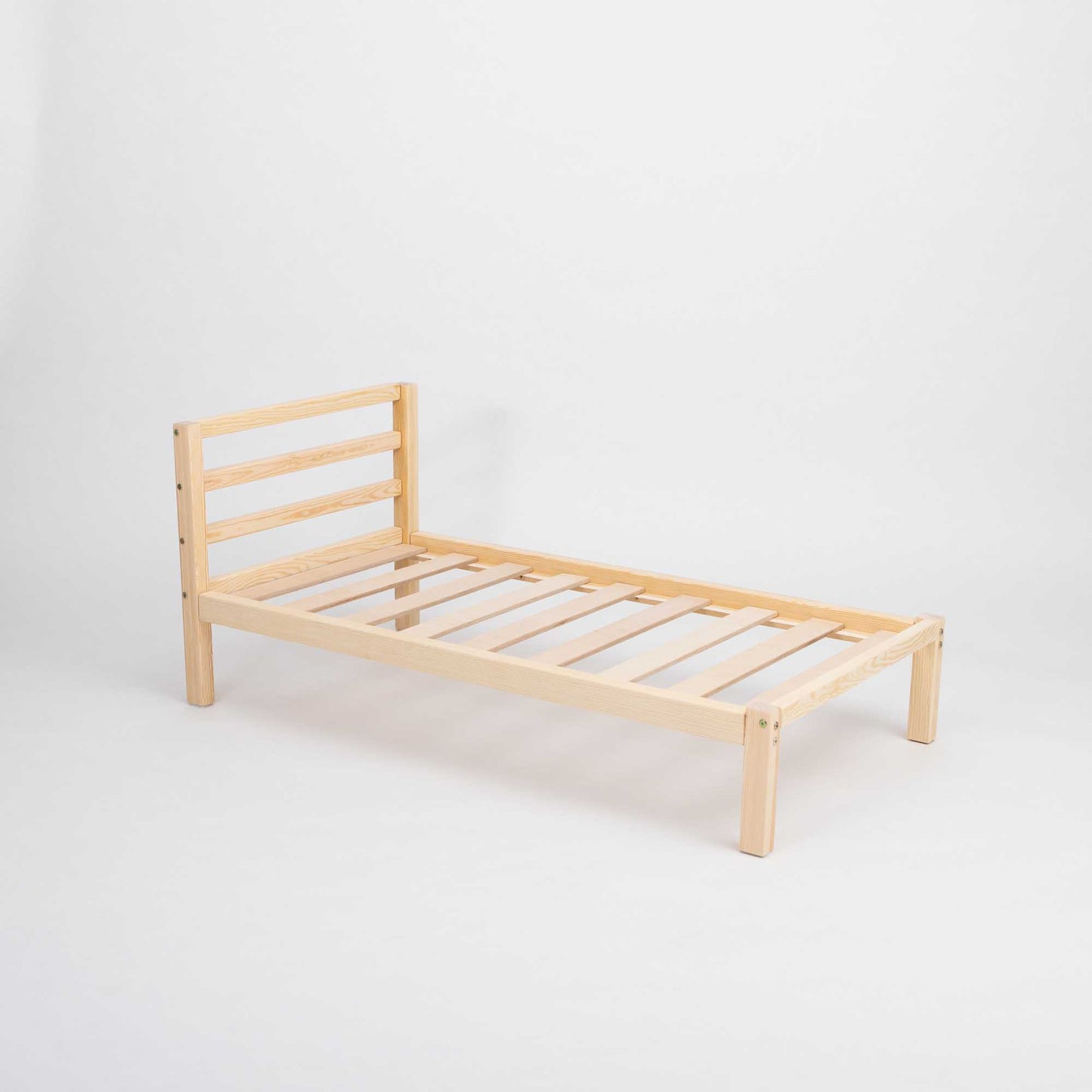 A Kids' bed on legs with a horizontal rail headboard from Sweet Home From Wood, with slats on a white background.