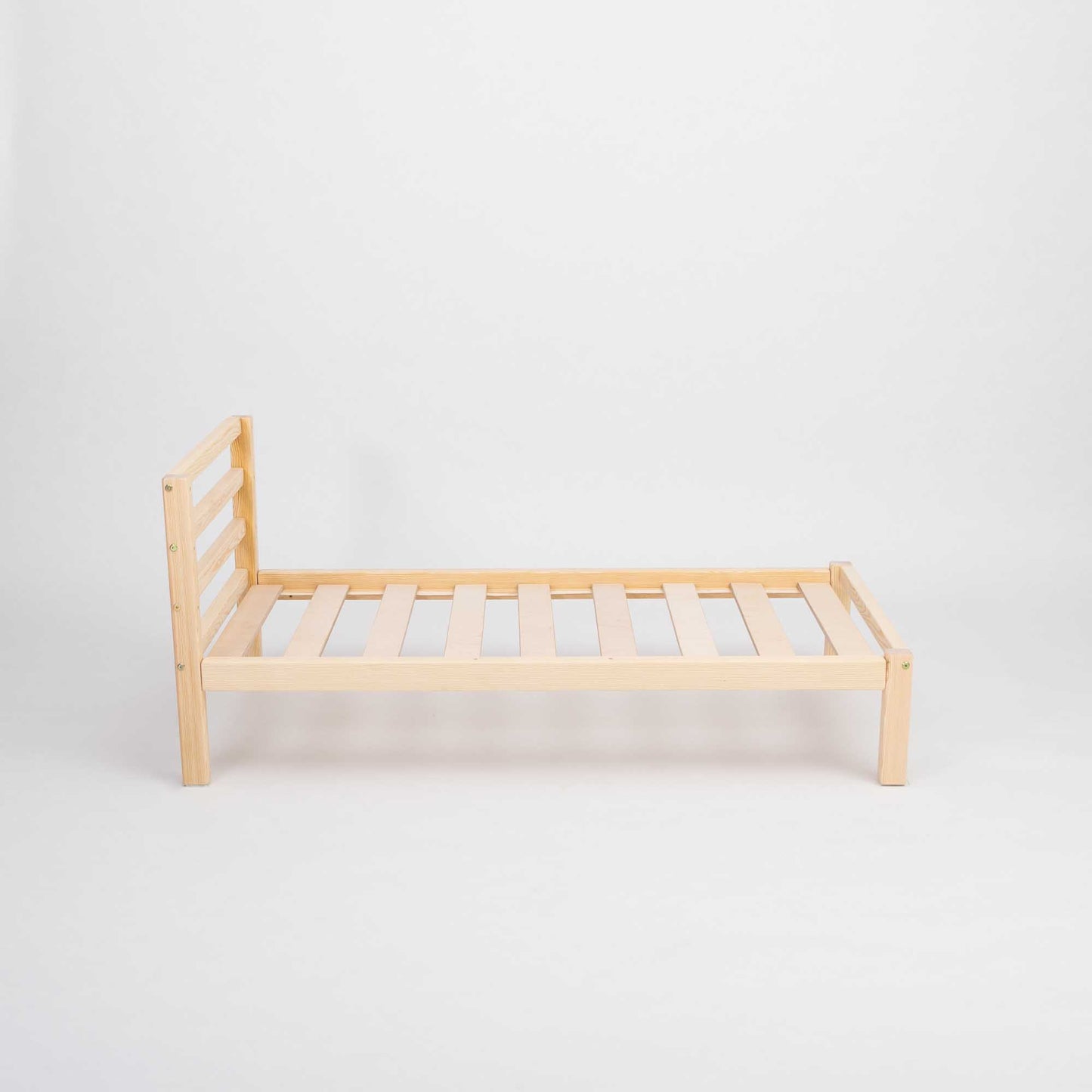 A sturdy "Sweet Home From Wood" kids' bed on legs with a horizontal rail headboard on a white background, perfect for co-sleeping or as a Montessori-inspired toddler bed.