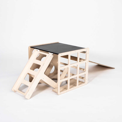 A transformable climbing cube / table and chair + ramp with a ladder on top.
