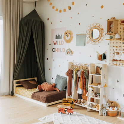 A child's room with a Sweet Home From Wood 2-in-1 transformable kids' bed with a horizontal rail headboard and toys that grow with the child.
