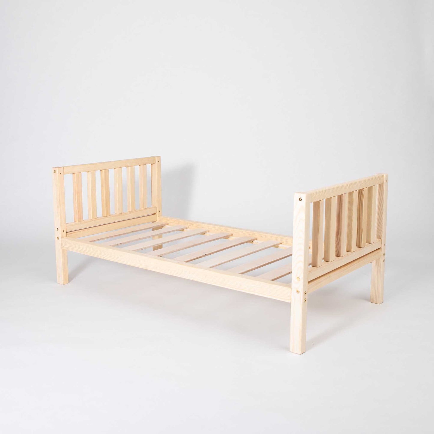 2-in-1 toddler bed on legs with a vertical rail headboard and footboard
