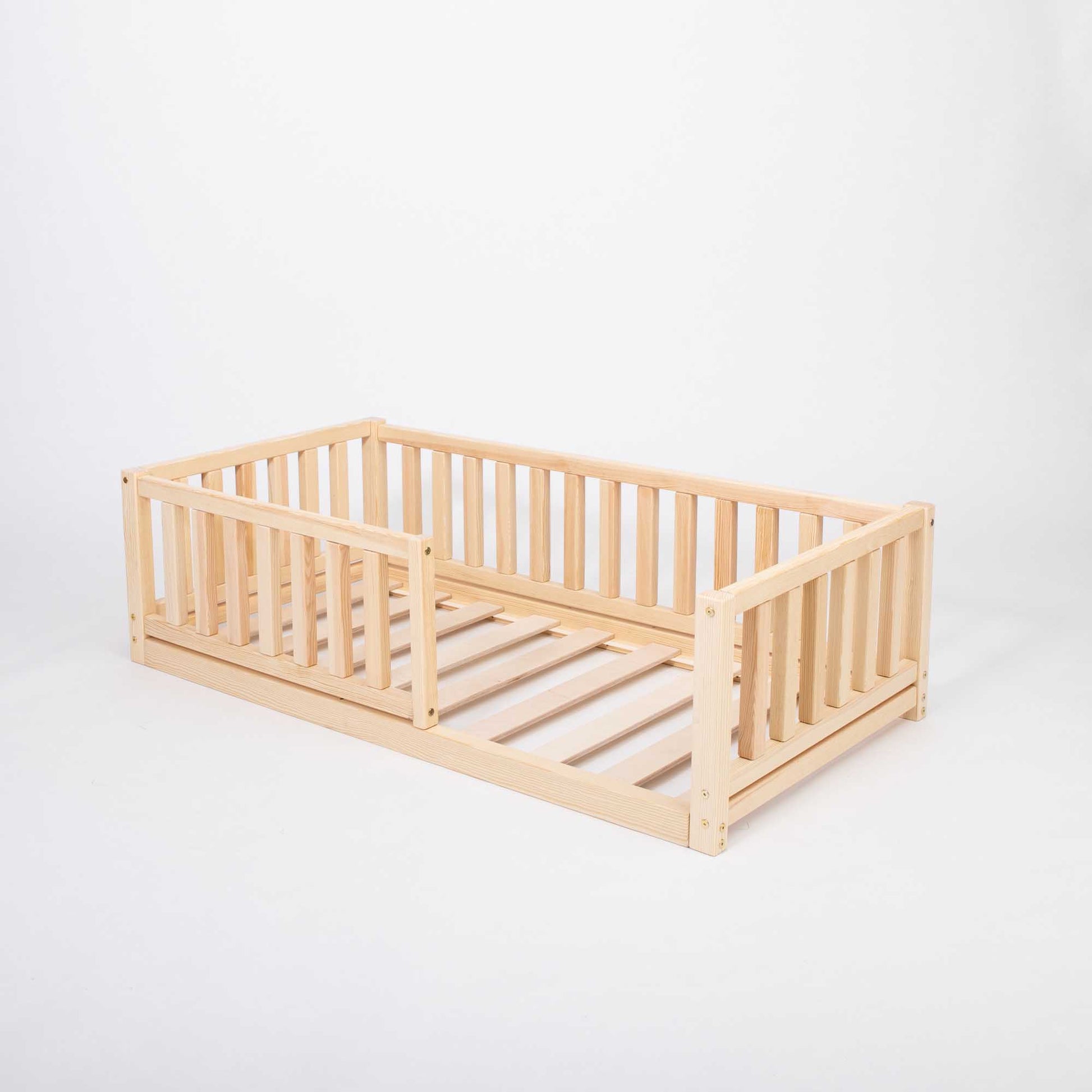 A 2-in-1 Sweet Home From Wood toddler bed on legs with a vertical rail fence, made from solid pine.