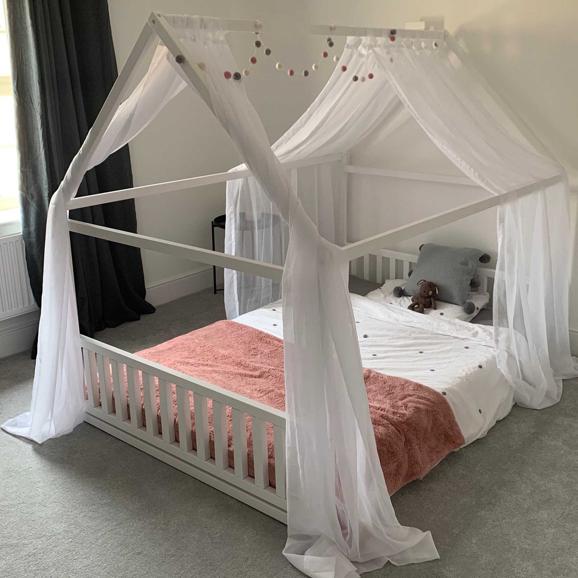 A Sweet Home From Wood Toddler house bed with a headboard and footboard that creates a sleep haven in the form of a house bed.