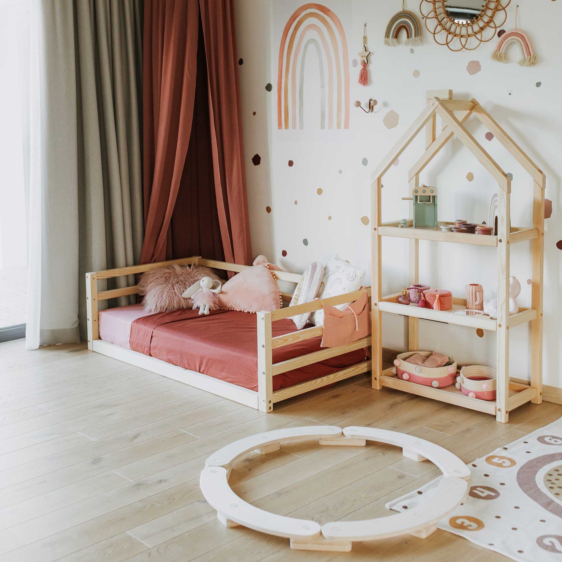 A child's room with a **Sweet Home From Wood 2-in-1 transformable kids' bed with a 3-sided horizontal rail**, a bedside table, and a rug featuring a 2-in-1 design.
