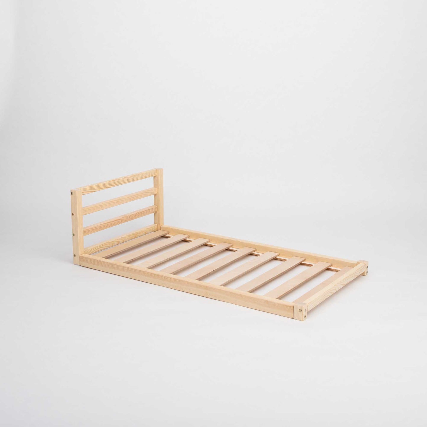 A 2-in-1 transformable kids' bed with a horizontal rail headboard from Sweet Home From Wood that can grow with the child, featuring slats on a white background.