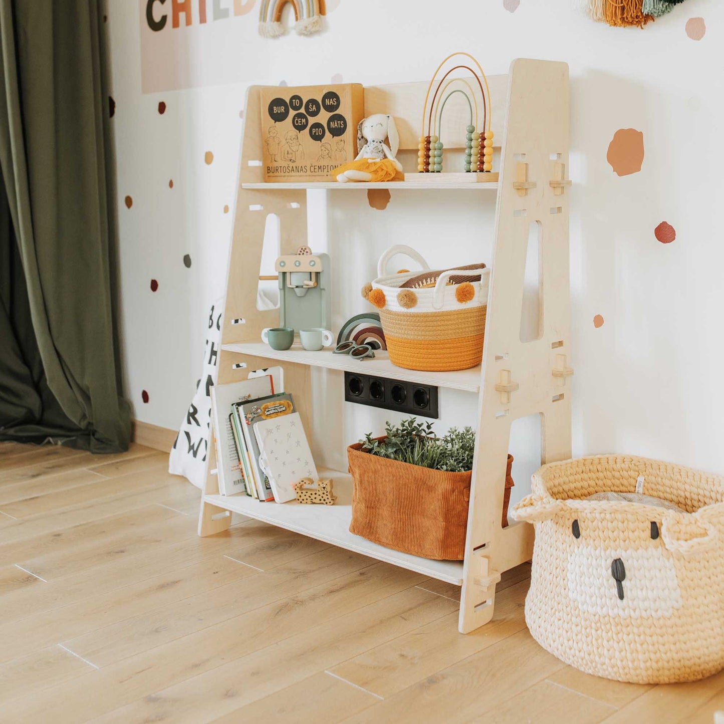 A child's room with an open Montessori toy shelf featuring wooden baskets for organizing toddler toys by Sweet Home From Wood.