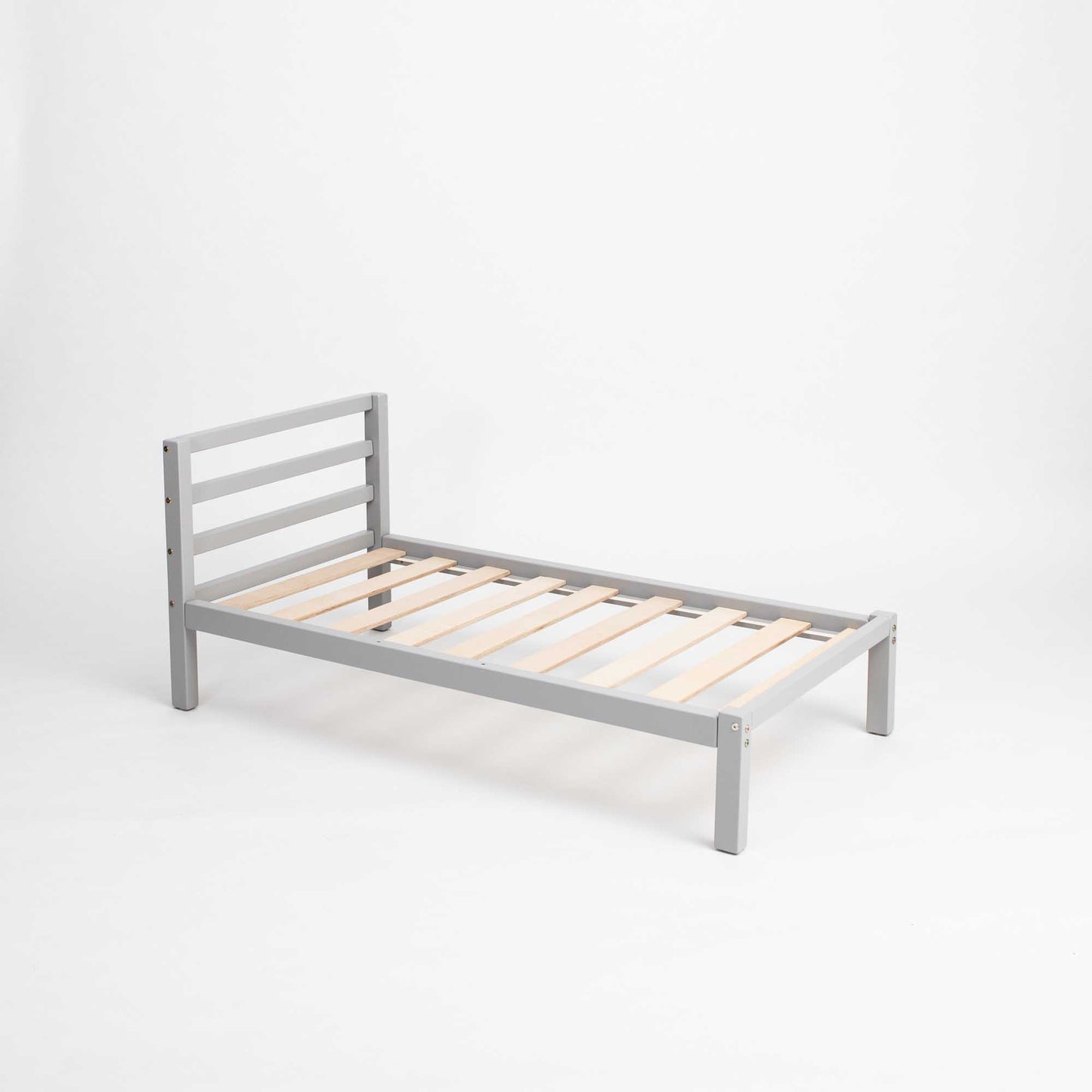 A sturdy, Sweet Home From Wood Montessori-inspired toddler bed with wooden slats on a white background.