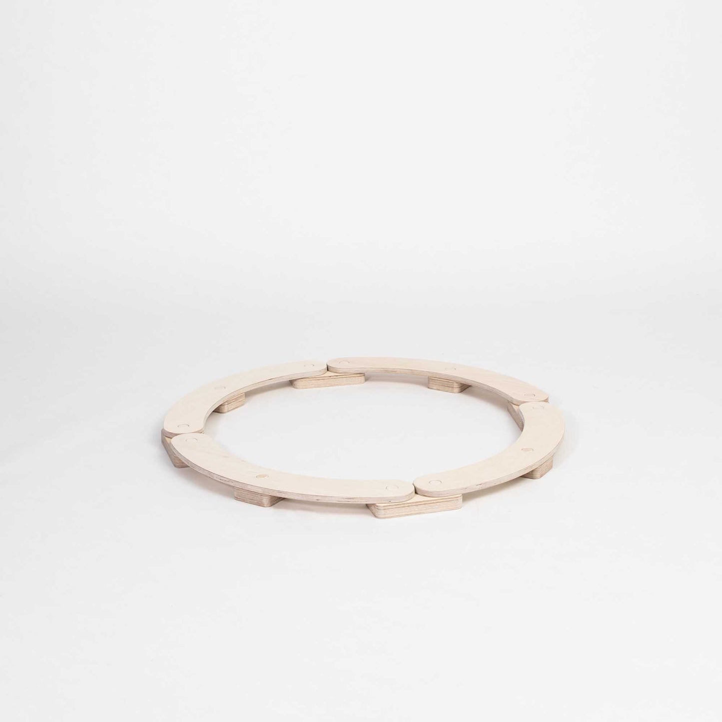 A Round balance beam with a wooden ring on a white background.