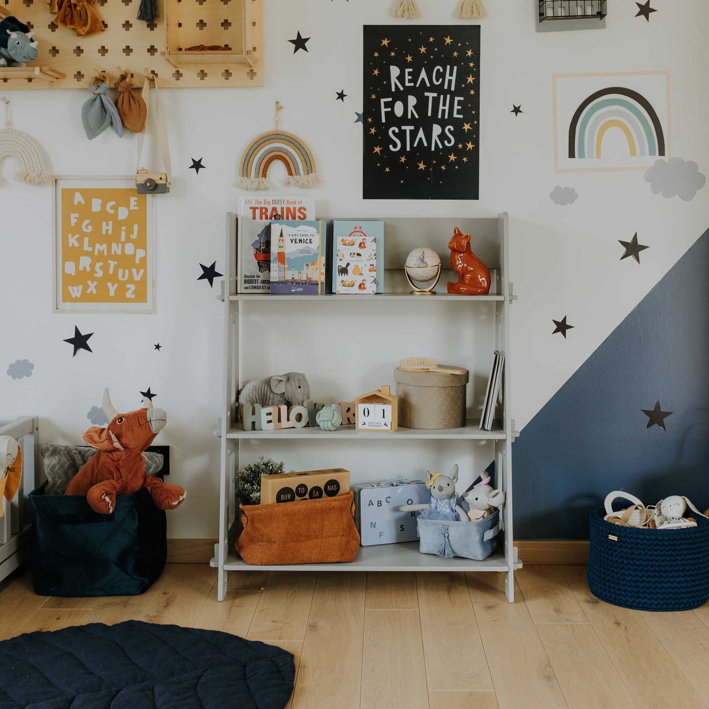 A child's room decorated with stars and a Sweet Home From Wood Montessori toy shelf.