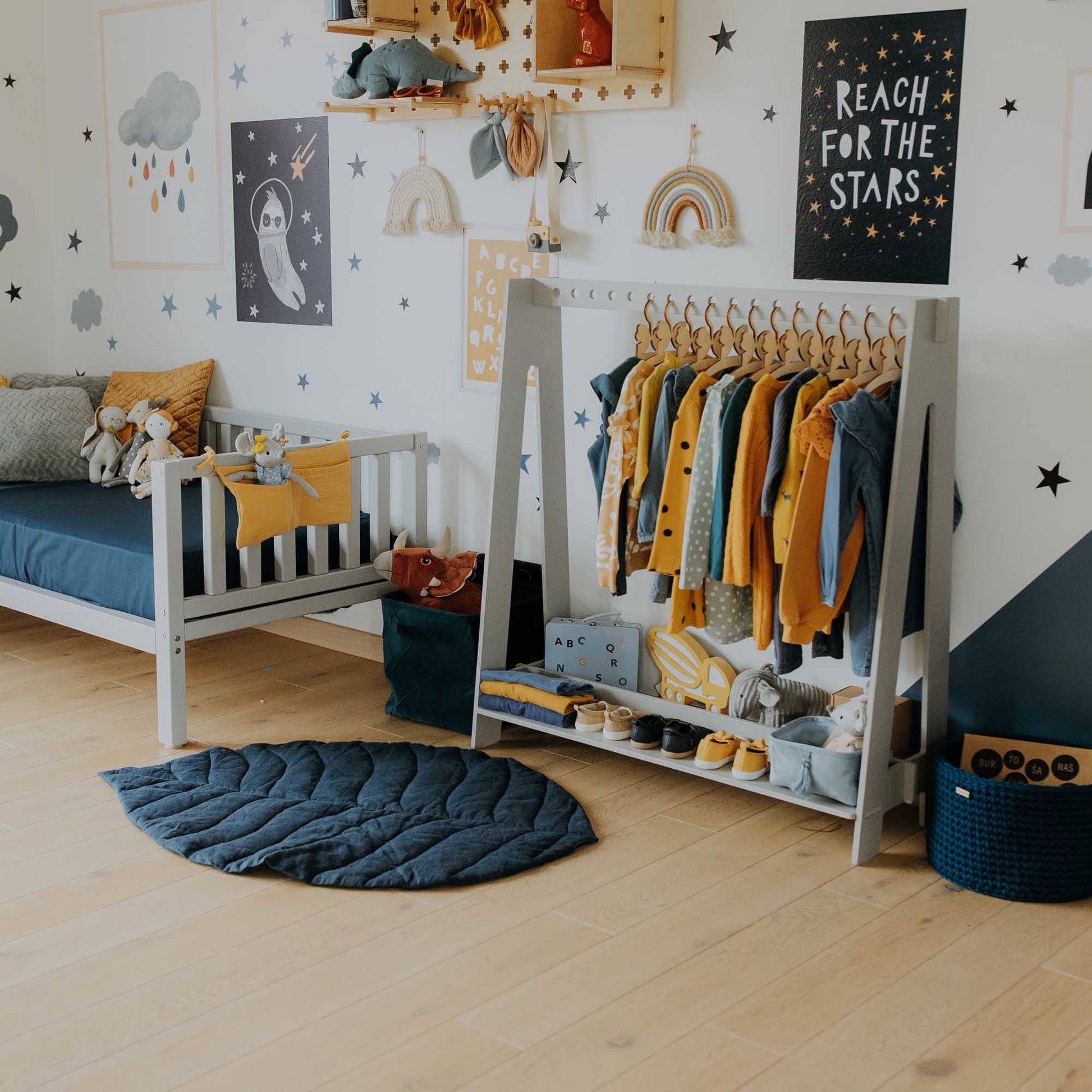 A child's room with a Sweet Home From Wood A-frame kids' clothing rack.