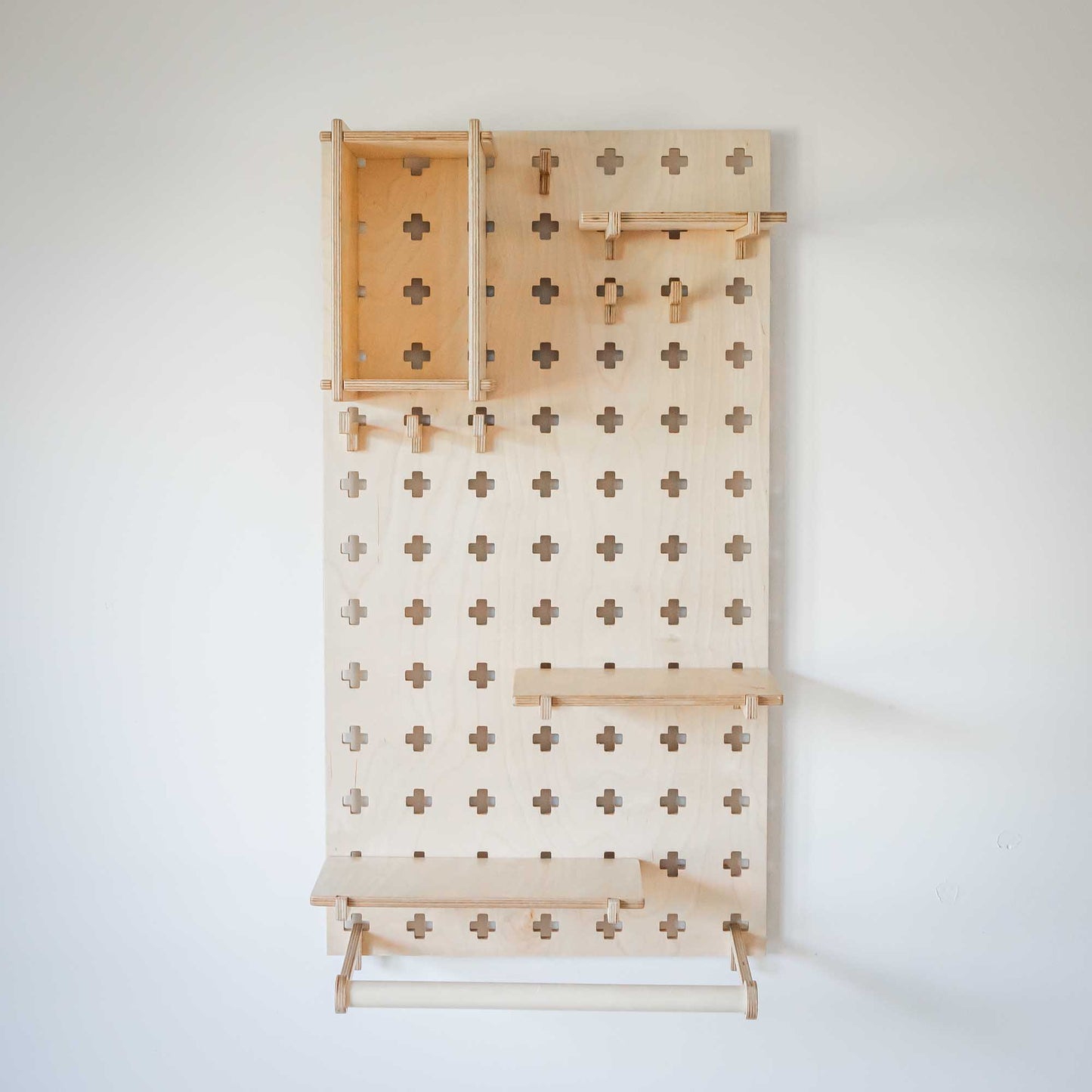 A Sweet HOME from wood pegboard with clothes hanger on it.