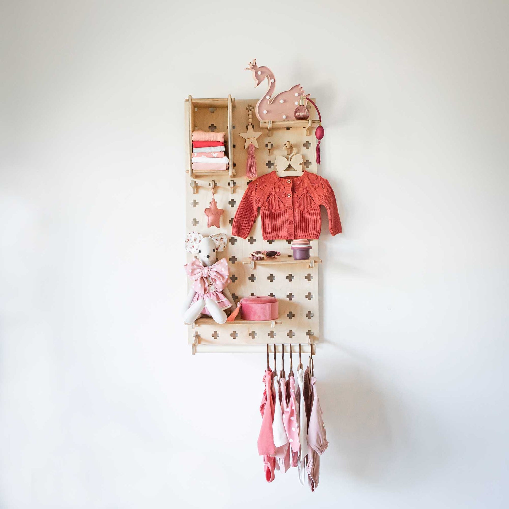 A Sweet HOME from wood Montessori-inspired toddler shelf with clothes and toys hanging on a Pegboard with Clothes Hanger.
