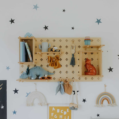A child's room with Sweet HOME from wood Pegboard Wall Shelves on the wall.